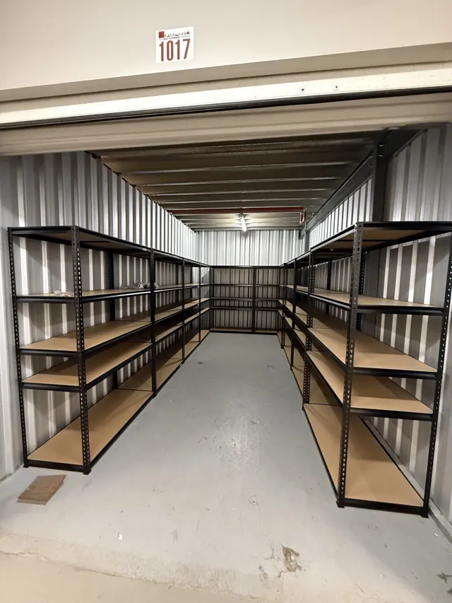 Storage unit fitted with black steel and timber shelving
